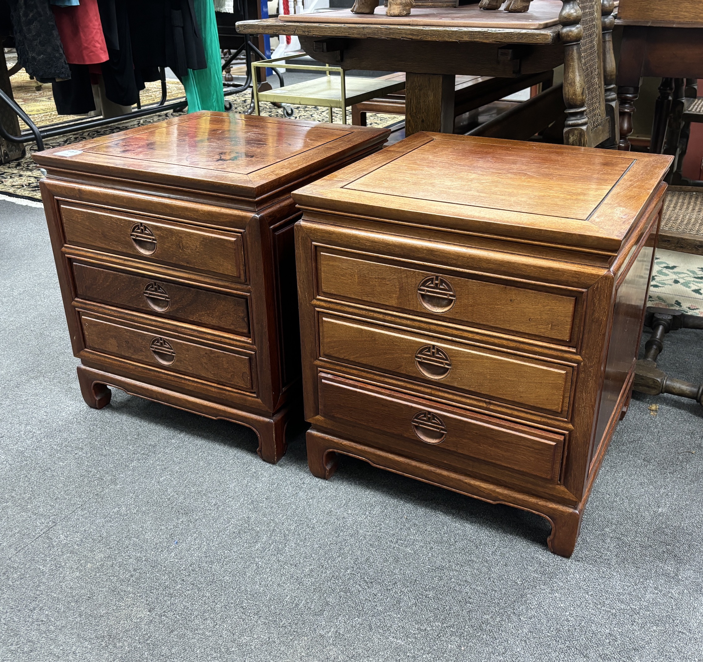 A pair of Chinese hardwood three drawer bedside chests, width 50cm, depth 50cm, height 56cm